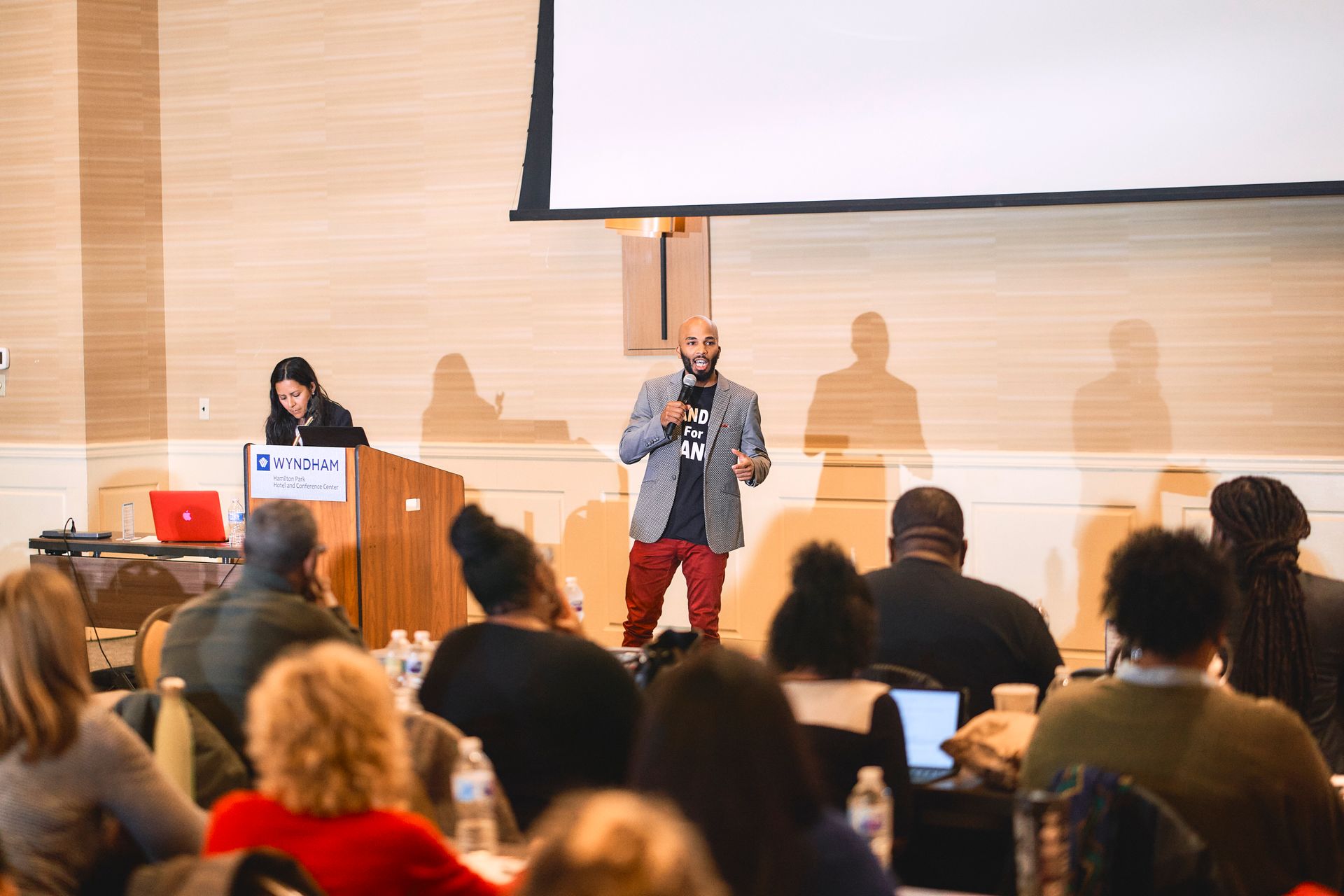 A man is giving a presentation to a group of people in a conference room.