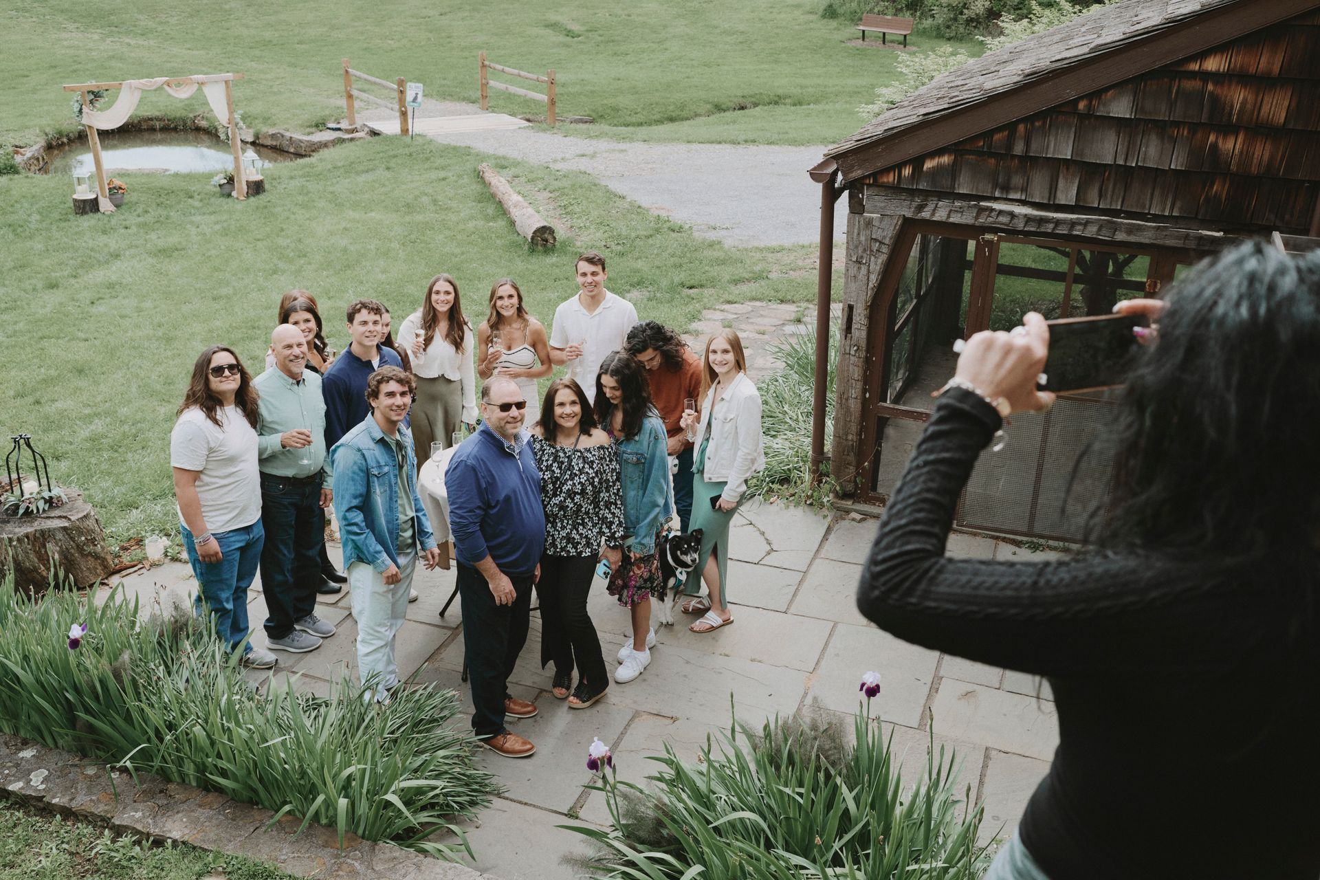 A woman is taking a picture of a group of people standing next to each other.