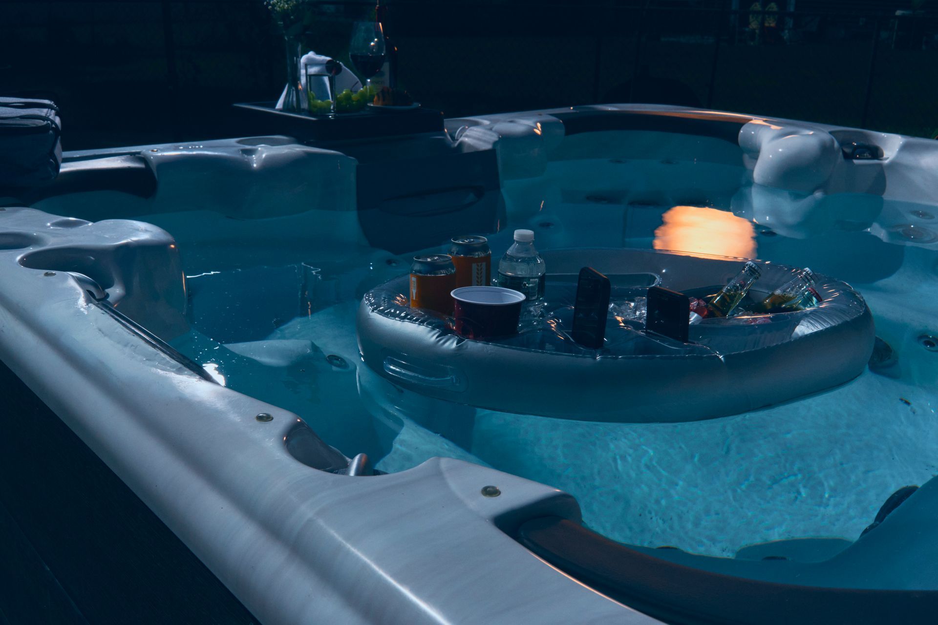 A large swimming pool with a floating table in the middle of it.