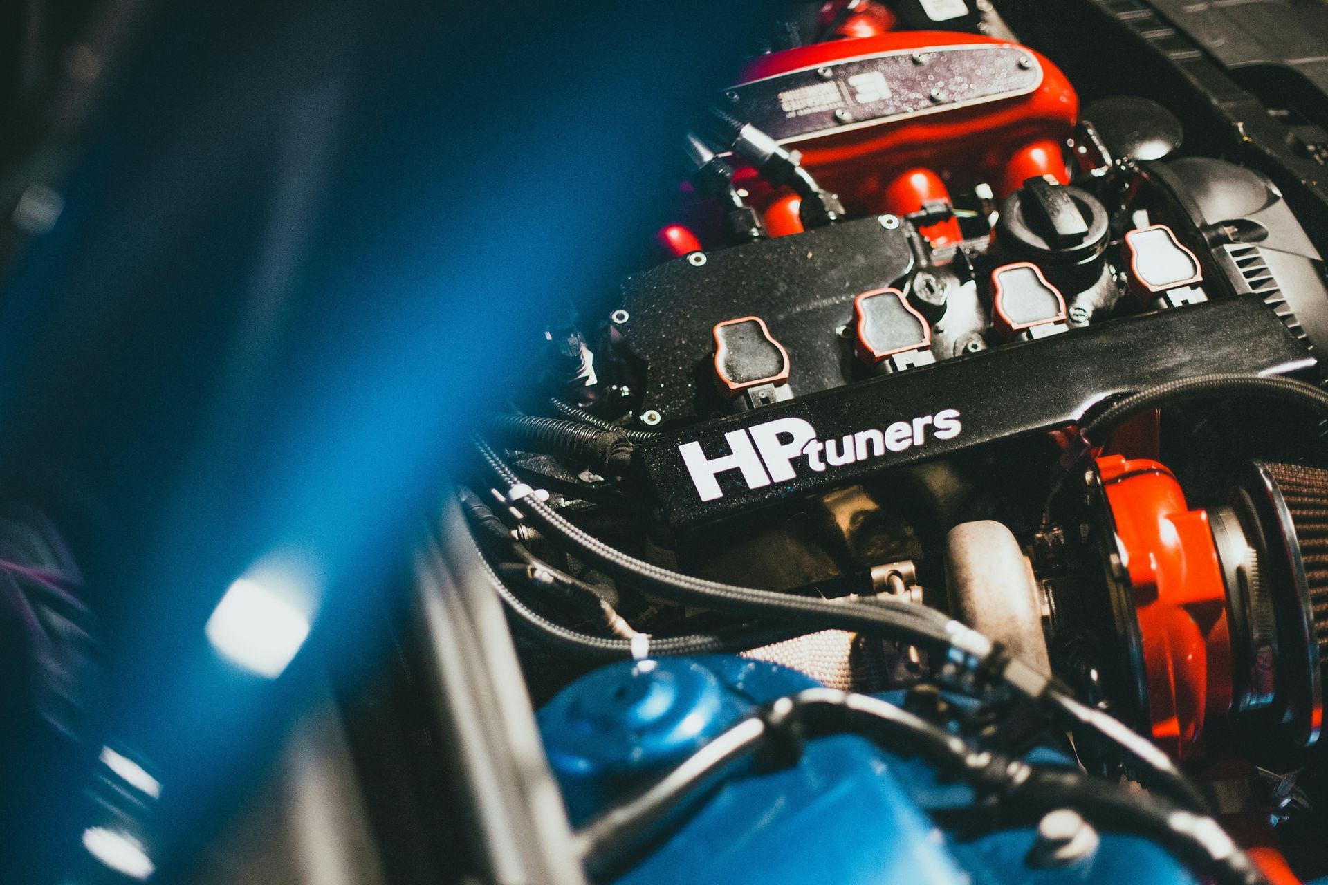 Blue car engine, red components, black 