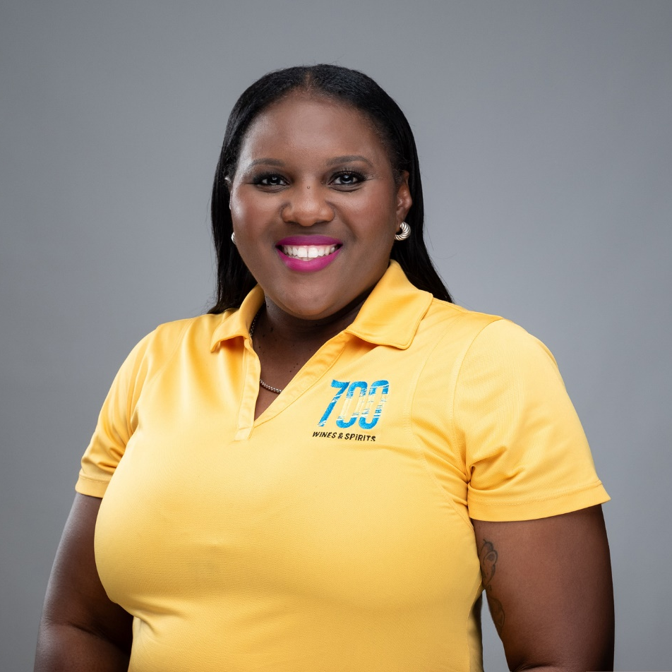 A woman wearing a yellow shirt with the number 703 on it