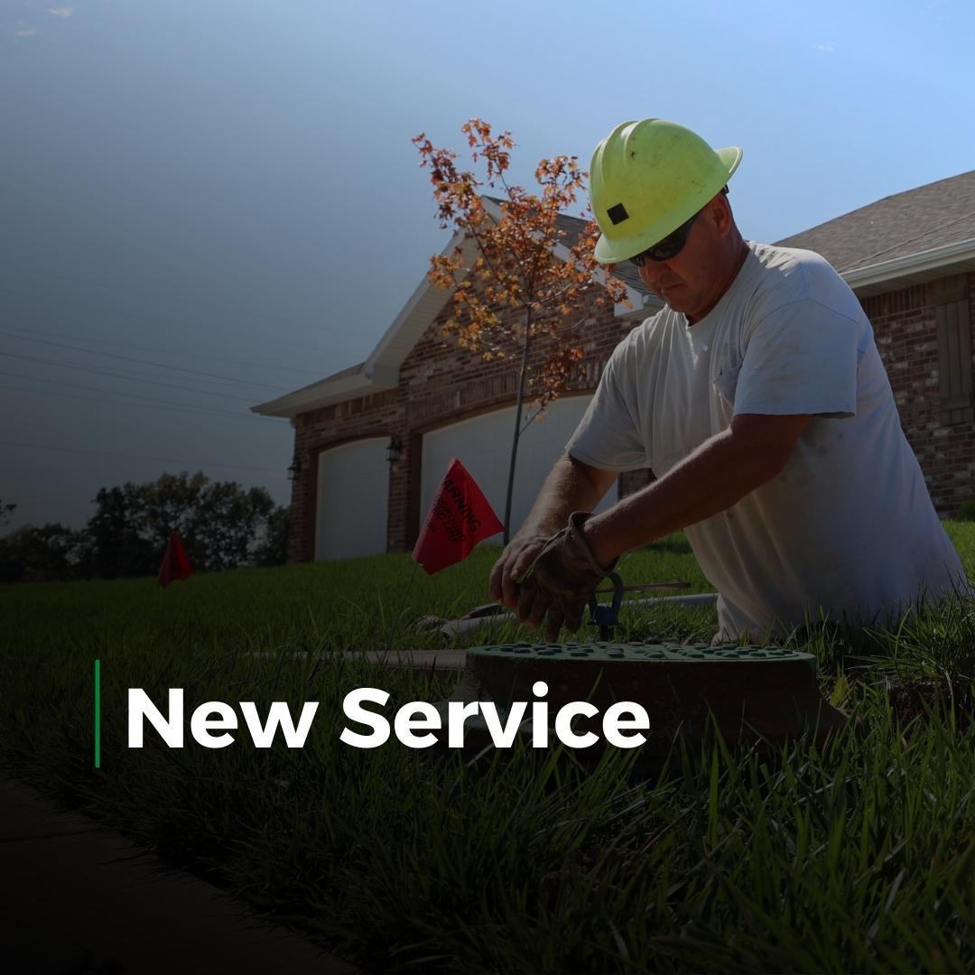 Worker in a yellow hard hat in a suburban yard, with “New Service” text overlay.