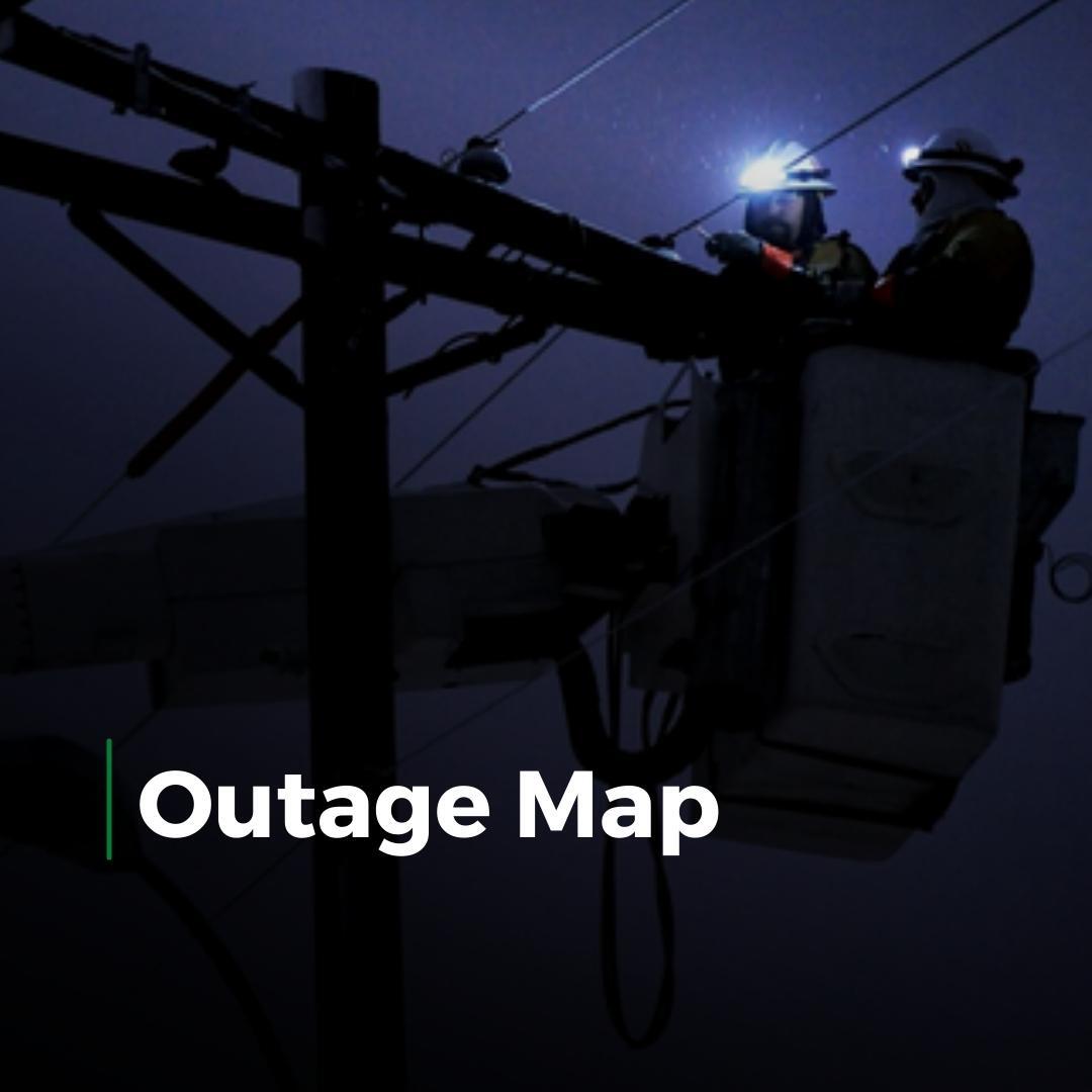 Utility workers repairing power lines at night with “Outage Map” text overlay