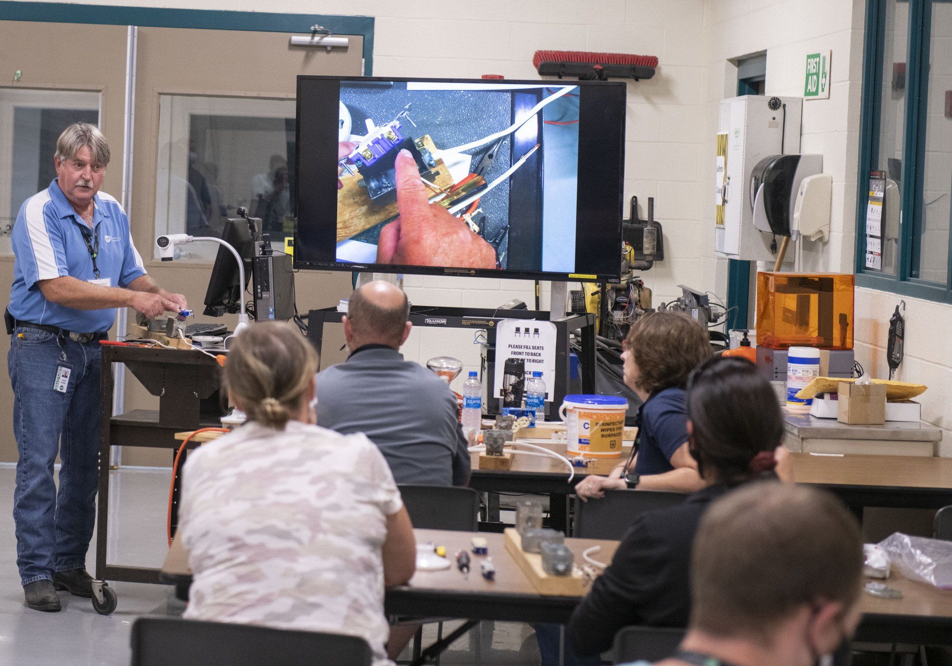 Instructor presenting to seated audience in a workshop