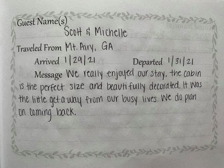 Guestbook note from Scott and Michelle thanking hosts for a stay in blue cursive handwriting