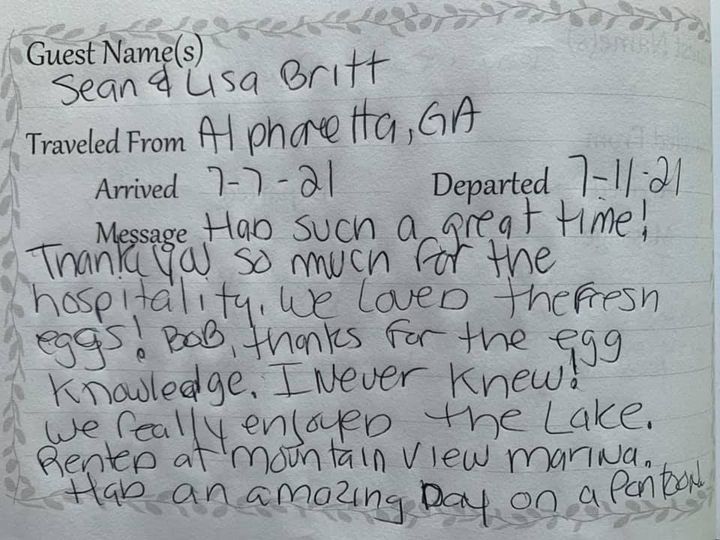 Guest book note thanking the hosts, mentioning a trip from Alpharetta, GA, and enjoying the lake views.