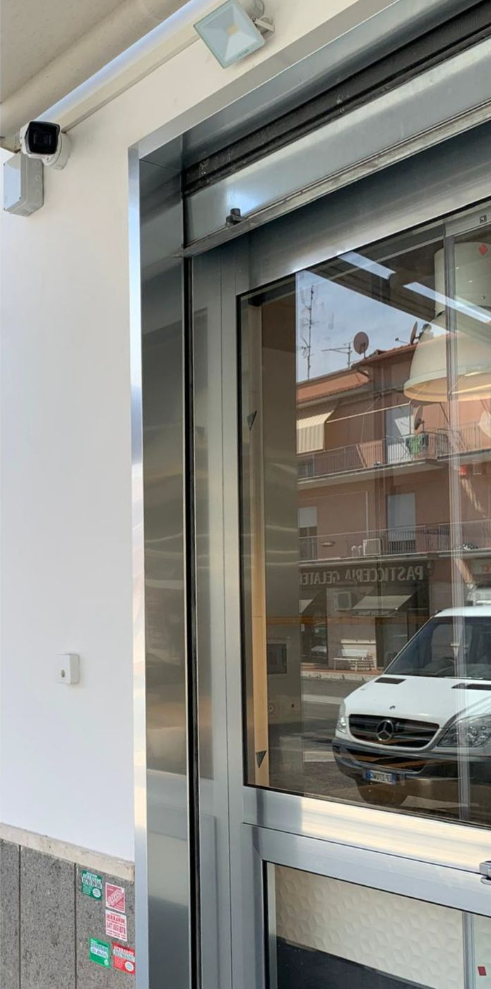 Vetrina del negozio con riflessi di auto parcheggiate e edifici vicini