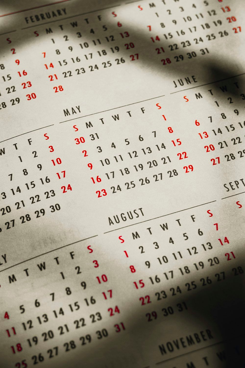 Close up of a paper calendar on a table with dates and notes