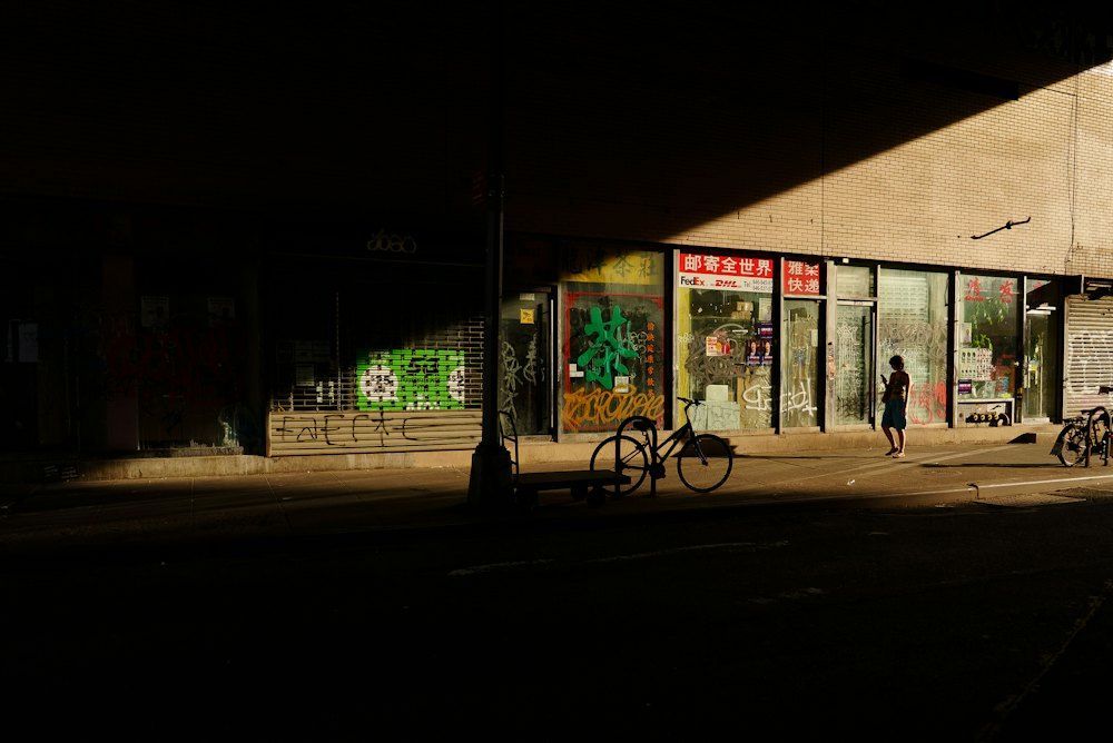 Sunlit city street lined with small storefronts