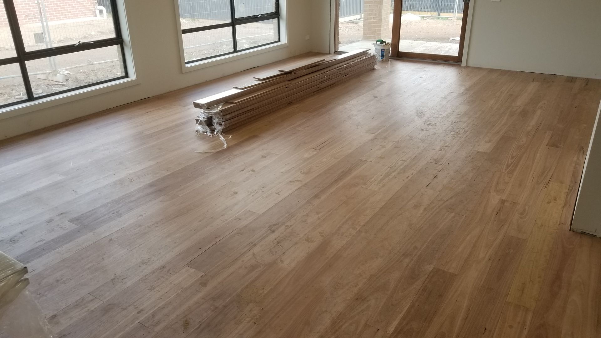 A wooden floor is being installed in a room.
