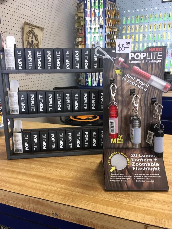 A display of poplite lanterns and flashlights on a wooden table.