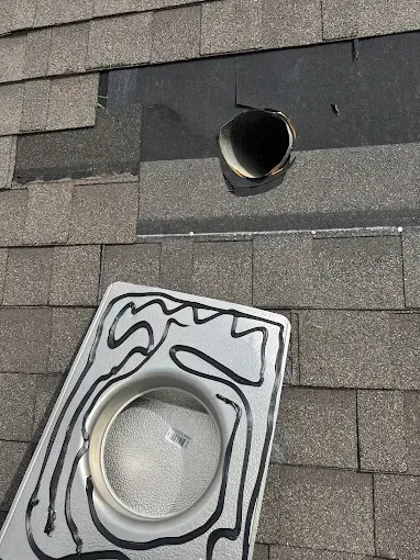A roof with a hole in it and a tray on top of it.