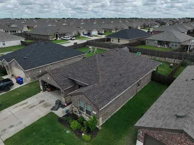 An aerial view of a residential area with houses and a garage.
