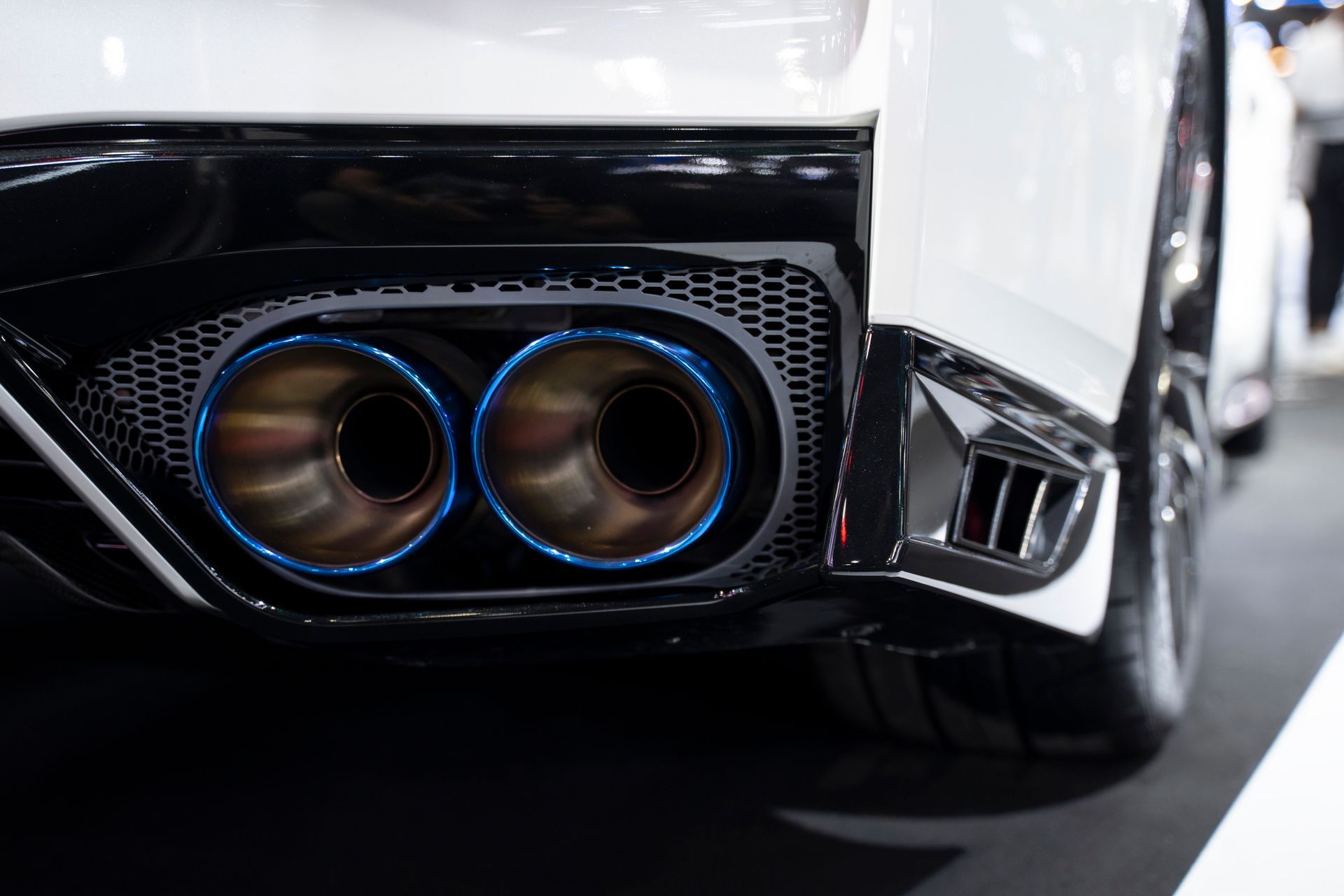 A close up of the exhaust pipe of a sports car.
