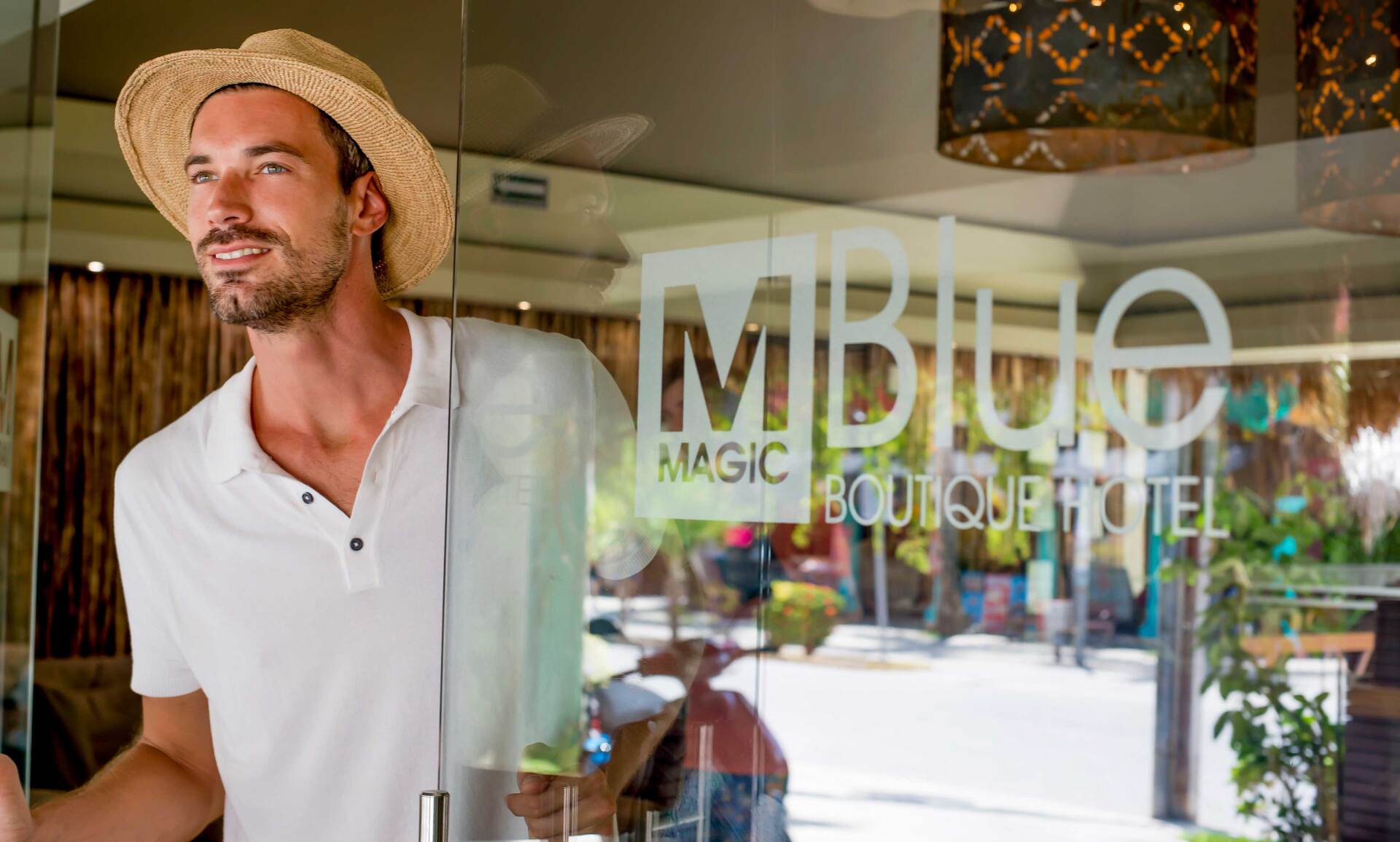 Man wearing straw hat exiting 