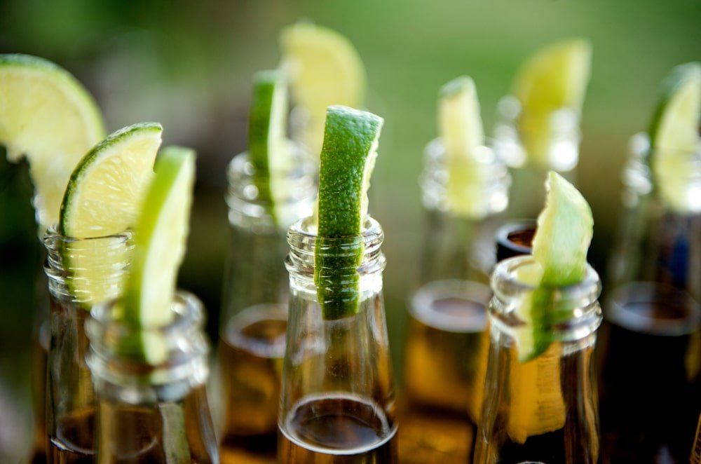 Botellas de cerveza con gajos de lima insertados en las aberturas.