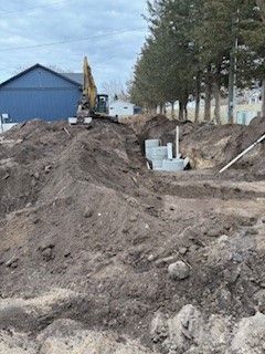 A group of construction workers are working on a road.