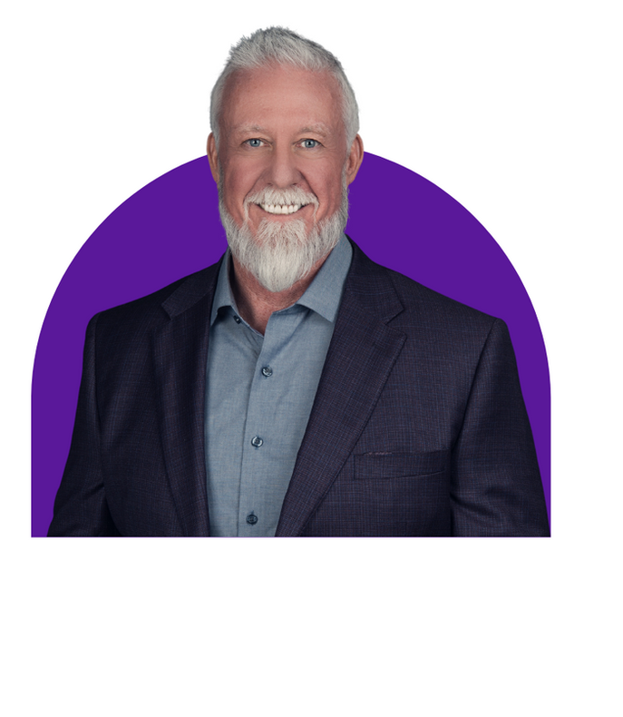 a man with a beard is wearing a suit and smiling.