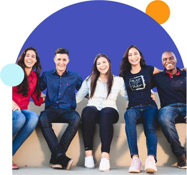 a group of people are sitting next to each other on a wall.