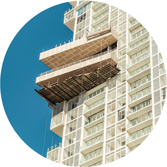 a very tall building under construction with a blue sky in the background.