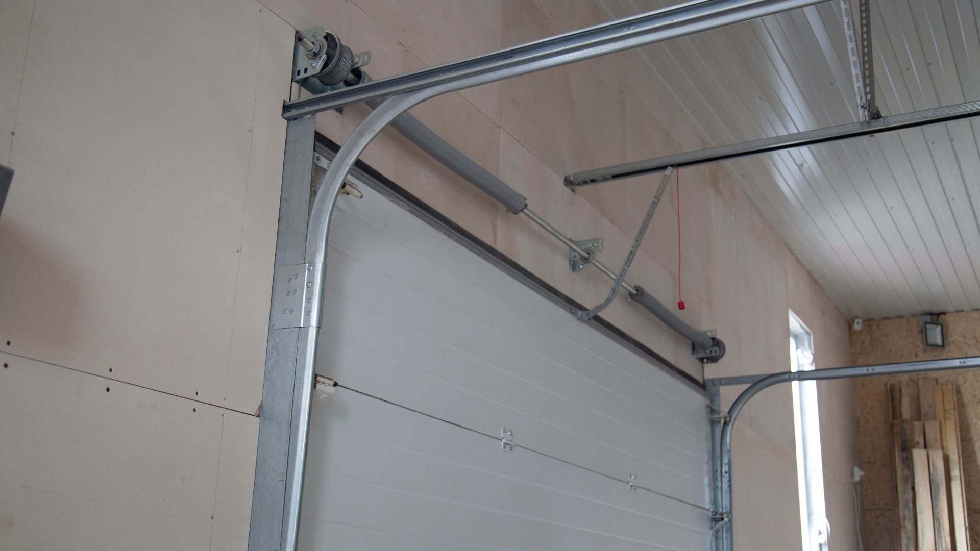 A garage door is being installed in a garage.