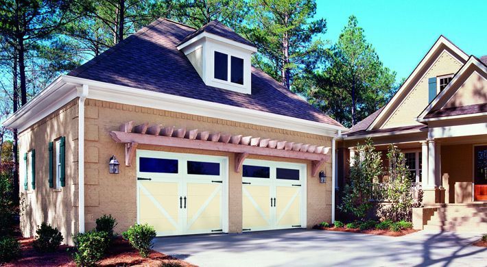 A house with a garage and a driveway in front of it.