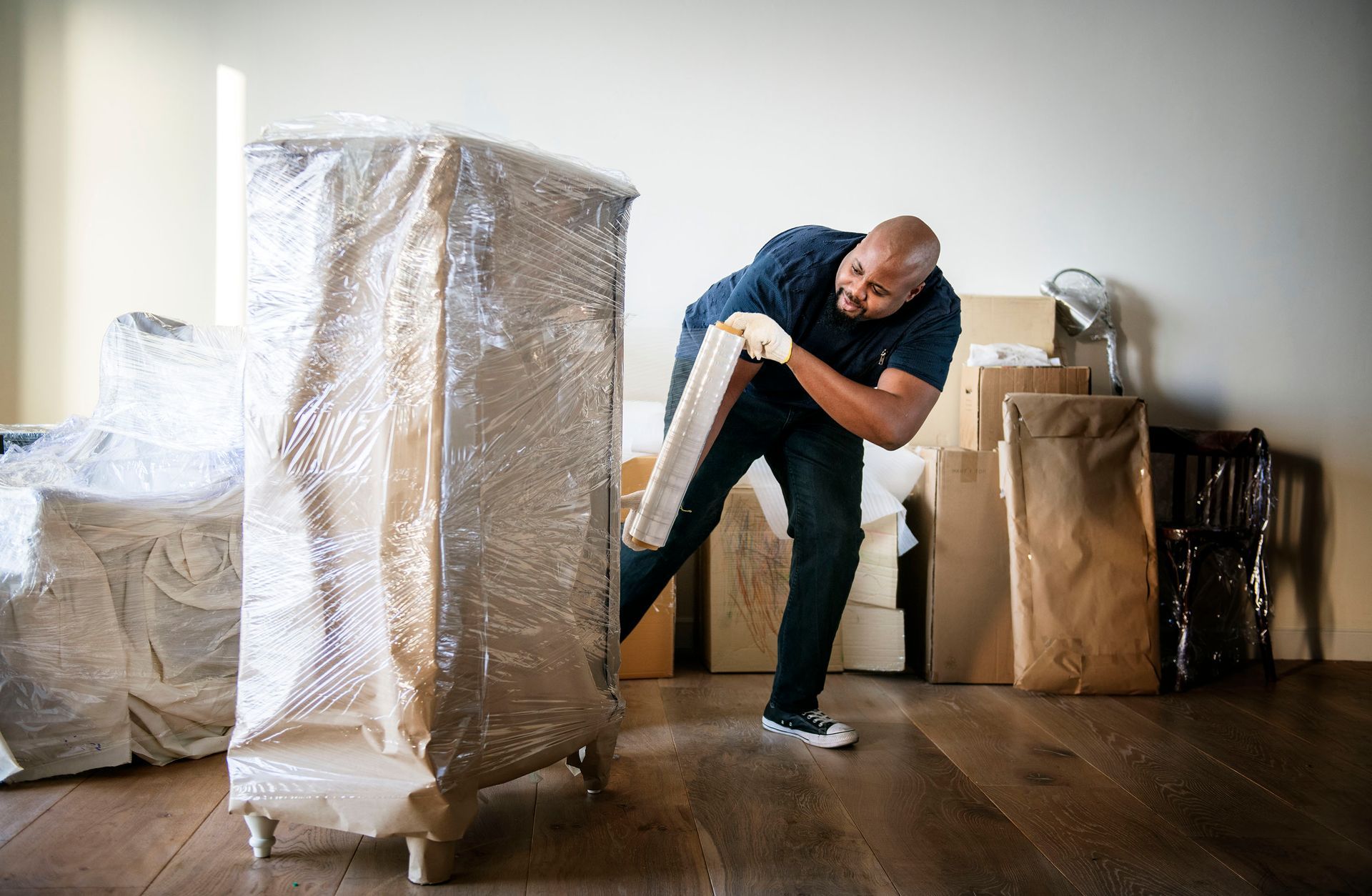 Man storing furniture in a climate controlled storage unit in Burlington, NC