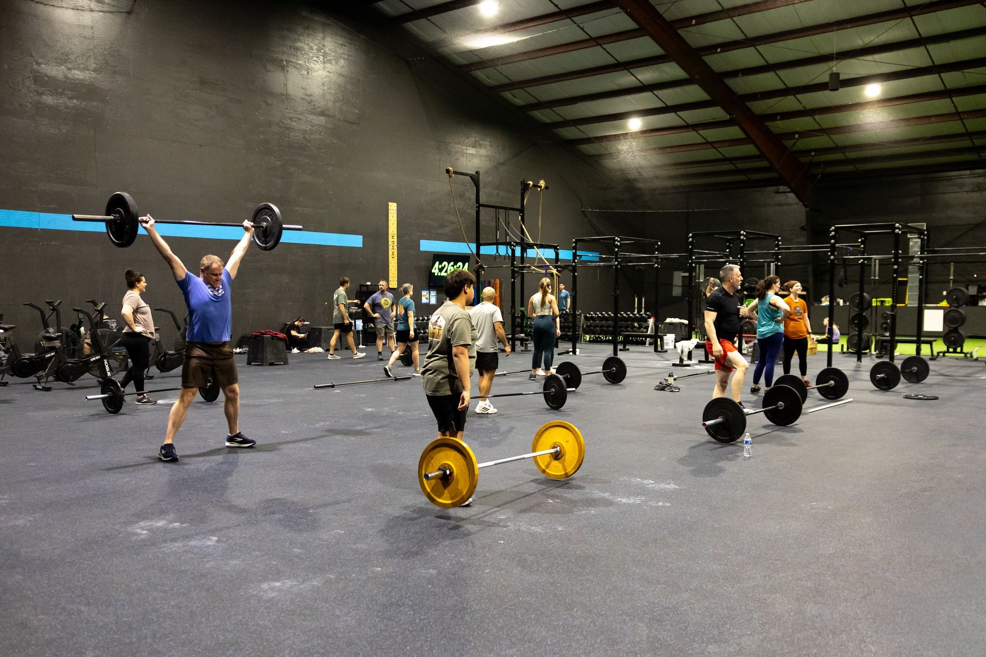 Wide view of the Freedom Fitness gym featuring cardio equipment, weight machines, free weights, and turf space.