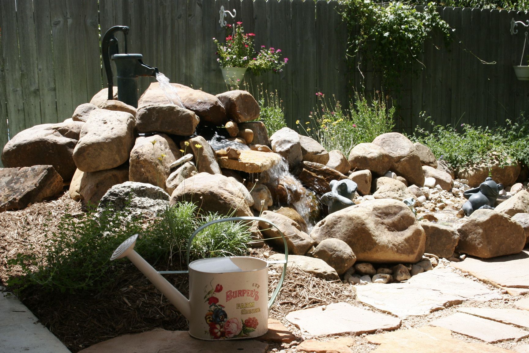 Boulder water feature with had pump
