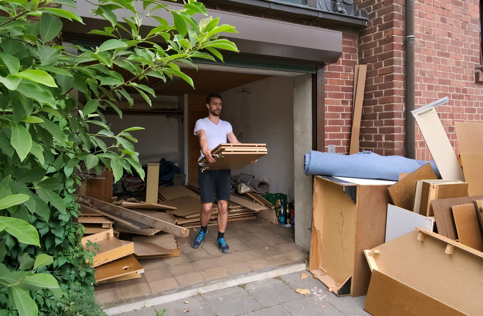 Your Helpful Neighbors team performing an estate cleanout, sorting and hauling items from a Michigan home.