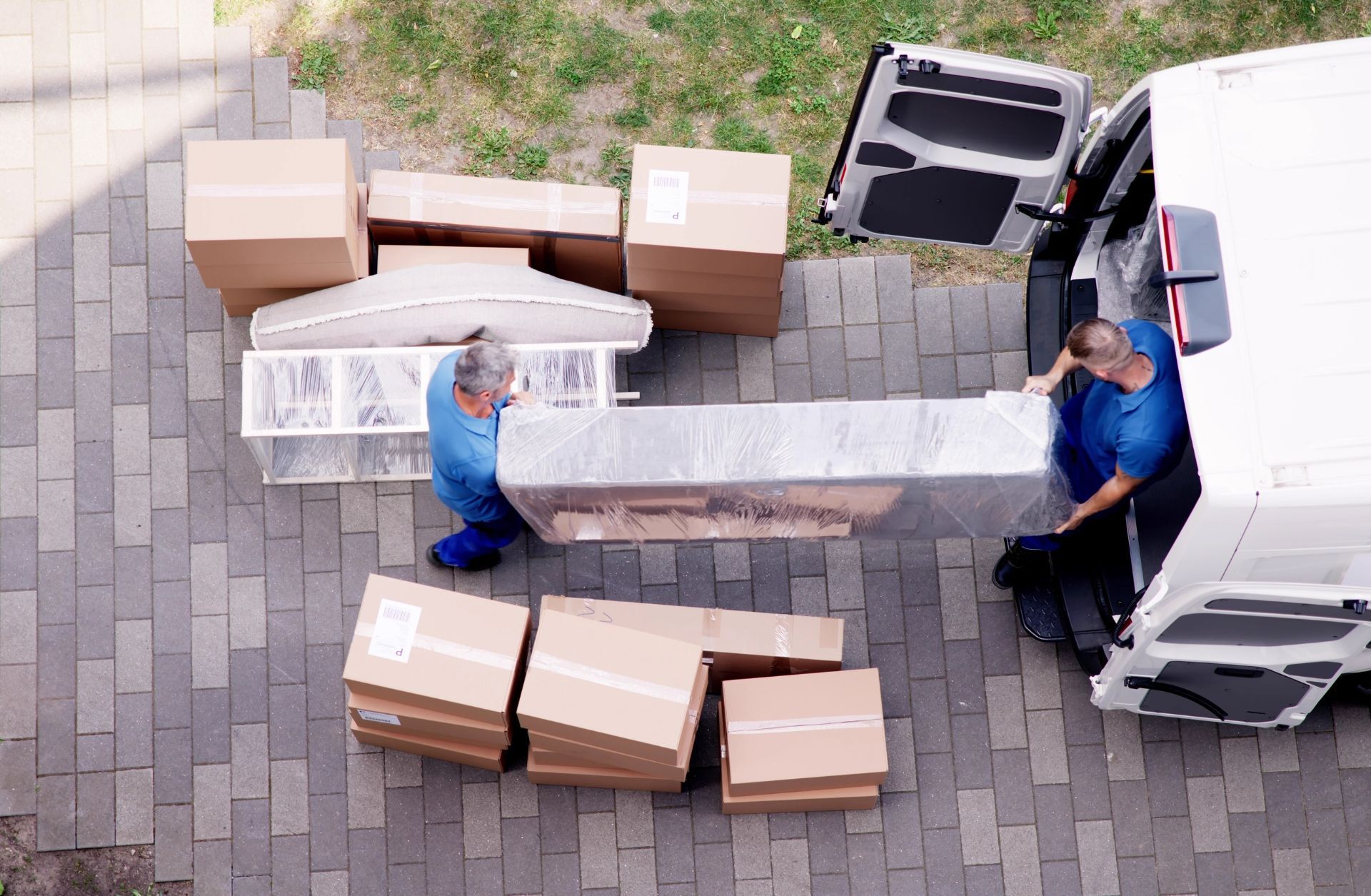 Your Helpful Neighbors junk removal crew loading items into a van for hauling and cleanout services in Ferndale, Michigan.”