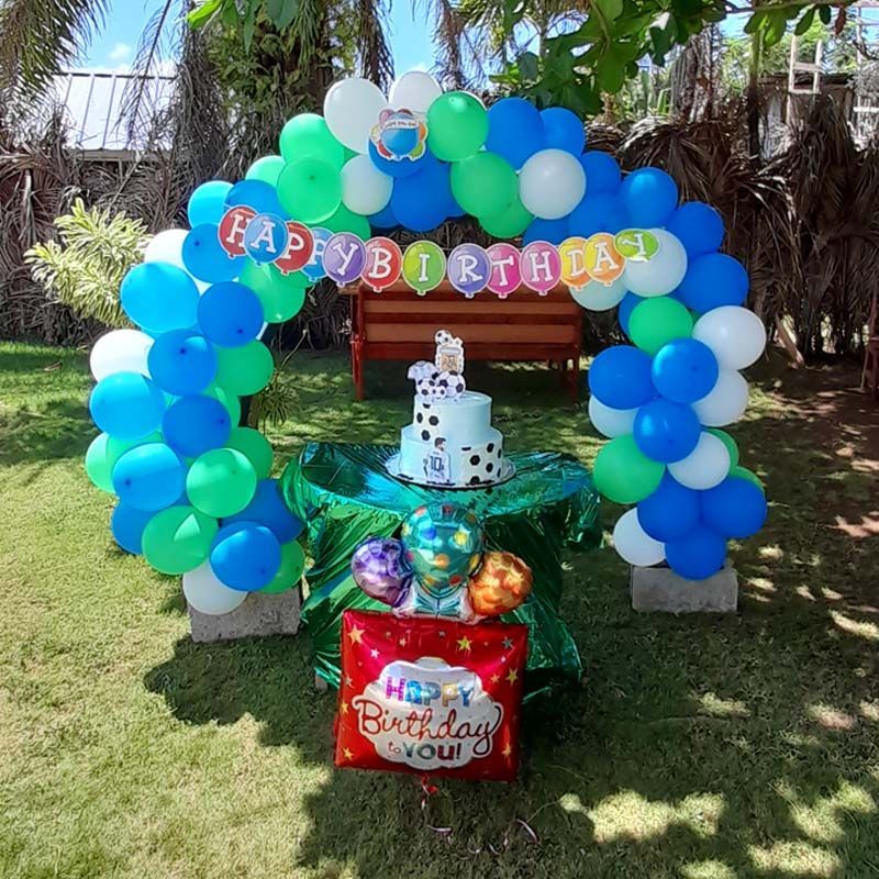 A birthday party with balloons and a cake on a table