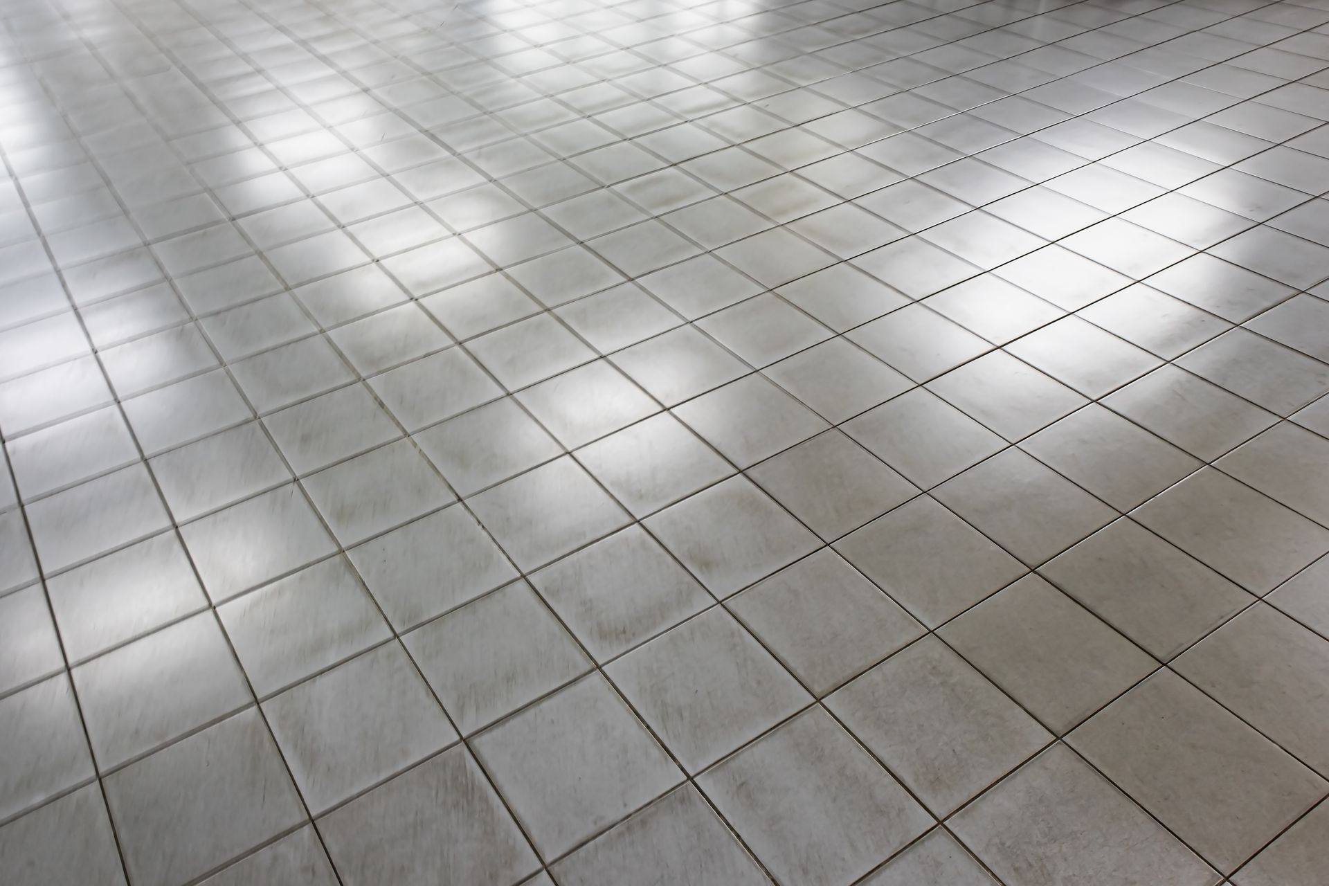 A close up of a tiled floor with a diamond pattern