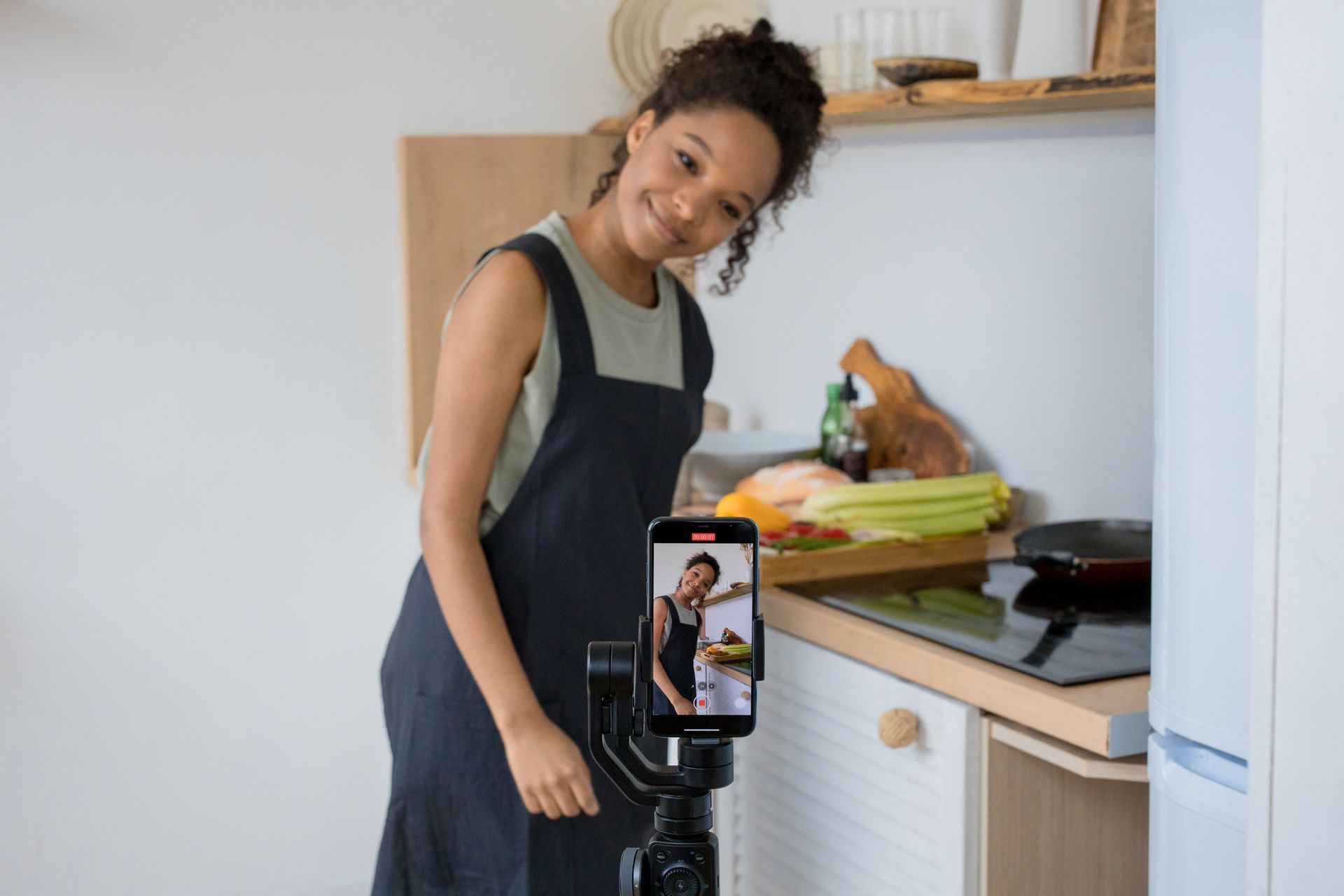 Small business owner filming a short video for social media in her kitchen