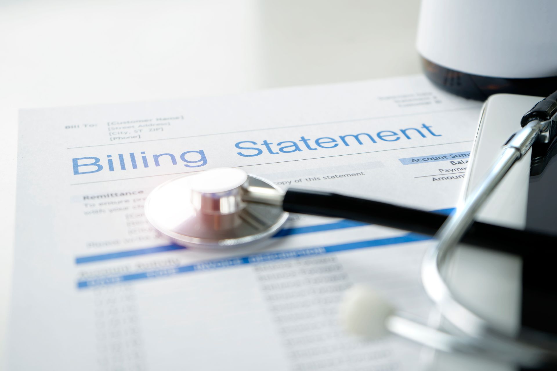 A billing statement with a stethoscope on top of it