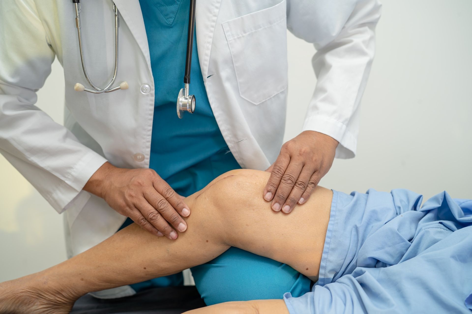 Image of a sports medicine doctor working on a patient's knee