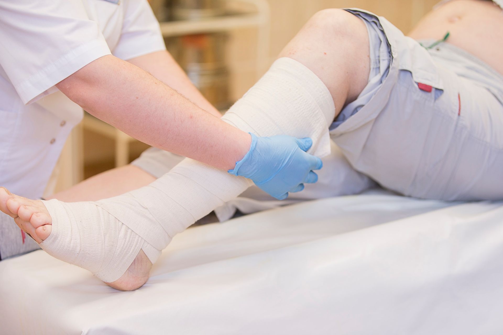 Image of a wound care specialist wrapping a leg with bandage