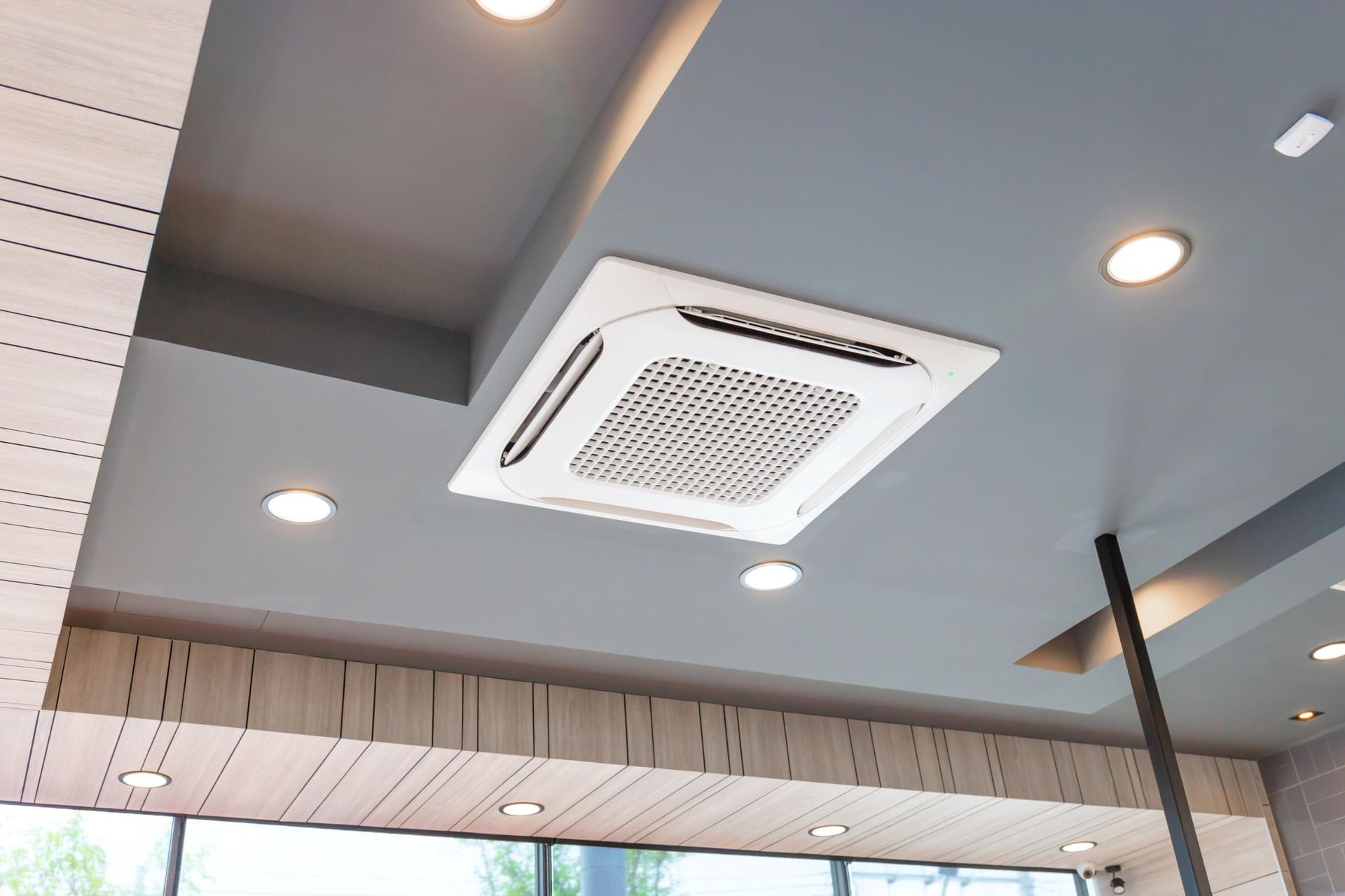 A Square Air Conditioner Is Hanging From The Ceiling Of A Room — Beards Refrigeration & Air Conditioning in Rural View, QLD