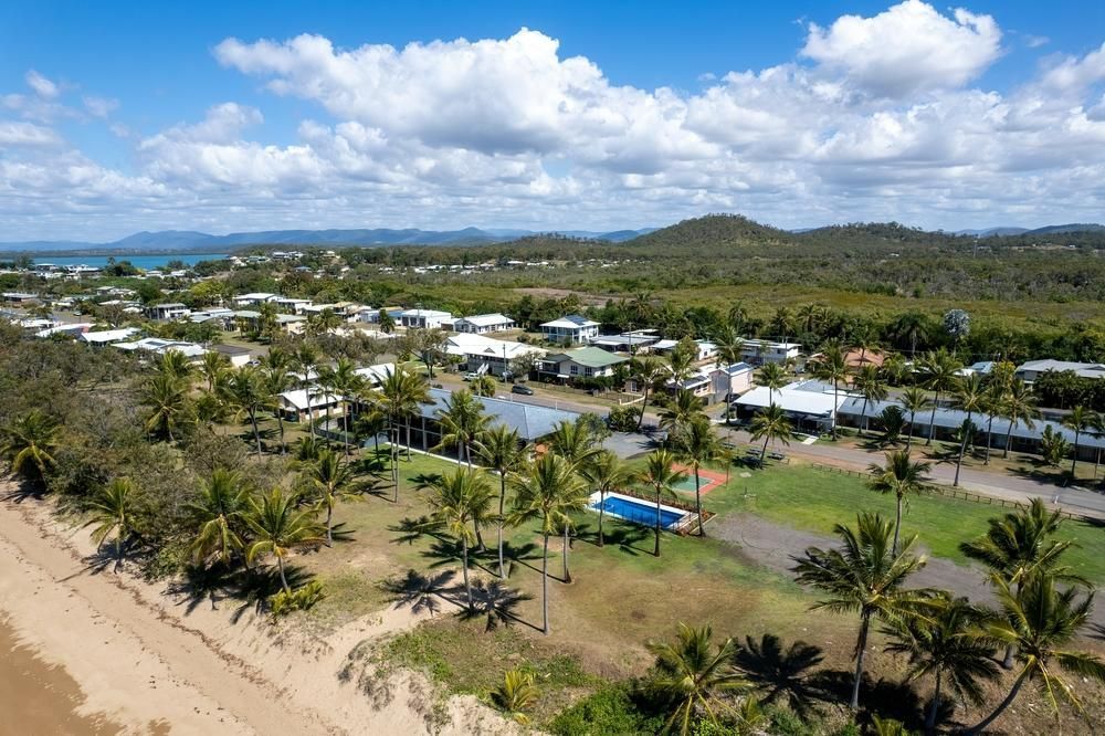 An Aerial View Of A Beach With Palm Trees And Houses — Beards Refrigeration & Air Conditioning in Sarina, QLD