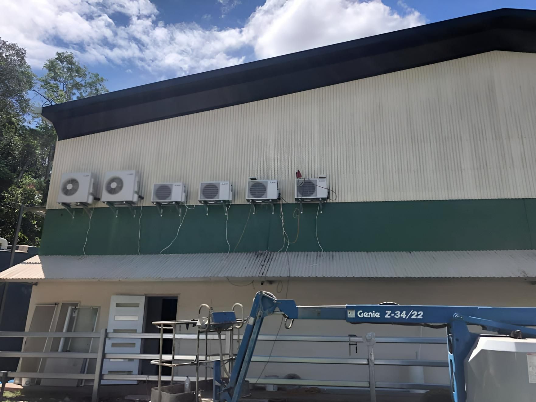 A Building With A Lot Of Air Conditioners On It — Beards Refrigeration & Air Conditioning in Mackay, QLD