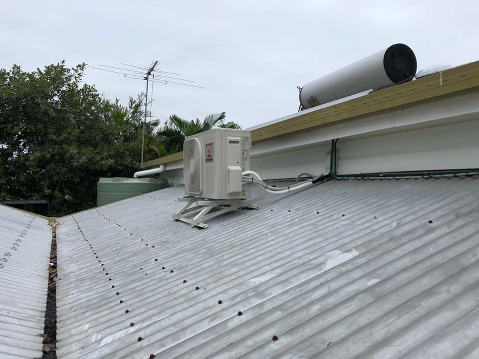 There Is A Water Heater On The Roof Of A Building — Beards Refrigeration & Air Conditioning in Bucasia, QLD