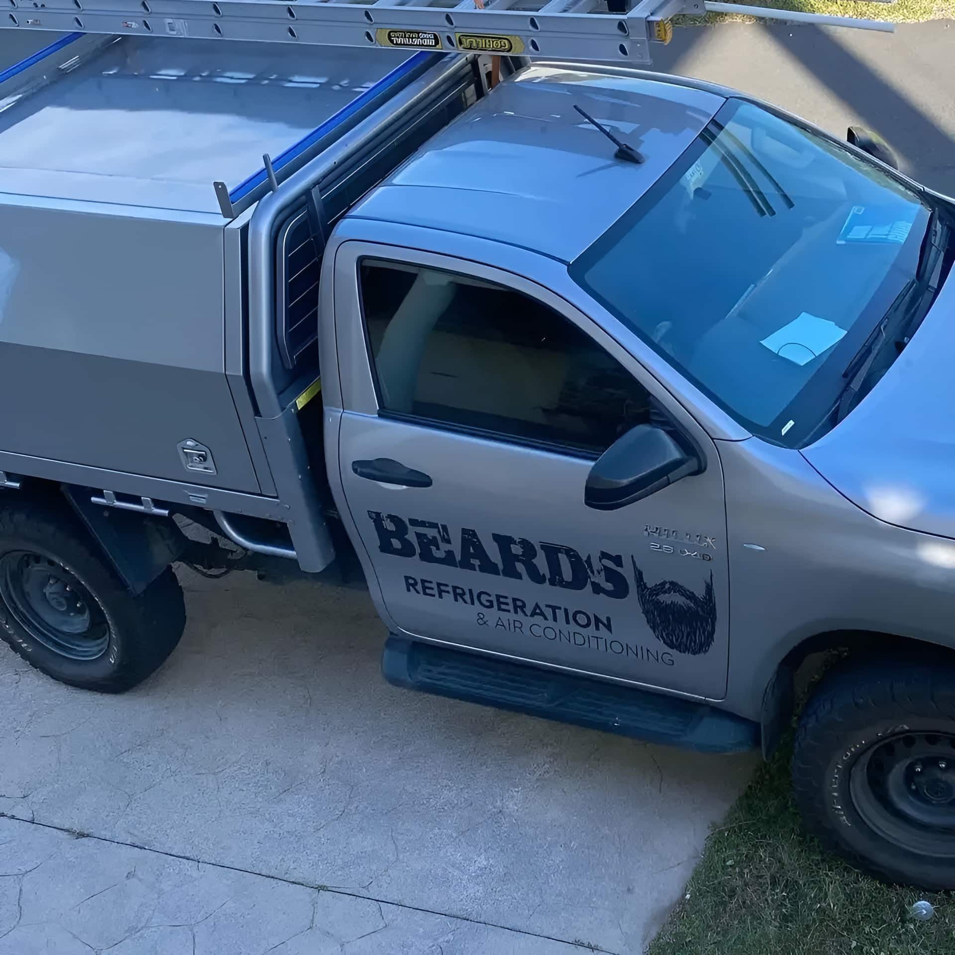 A Beard's Refrigeration Truck Is Parked On The Side Of The Road — Beards Refrigeration & Air Conditioning in Marian, QLD