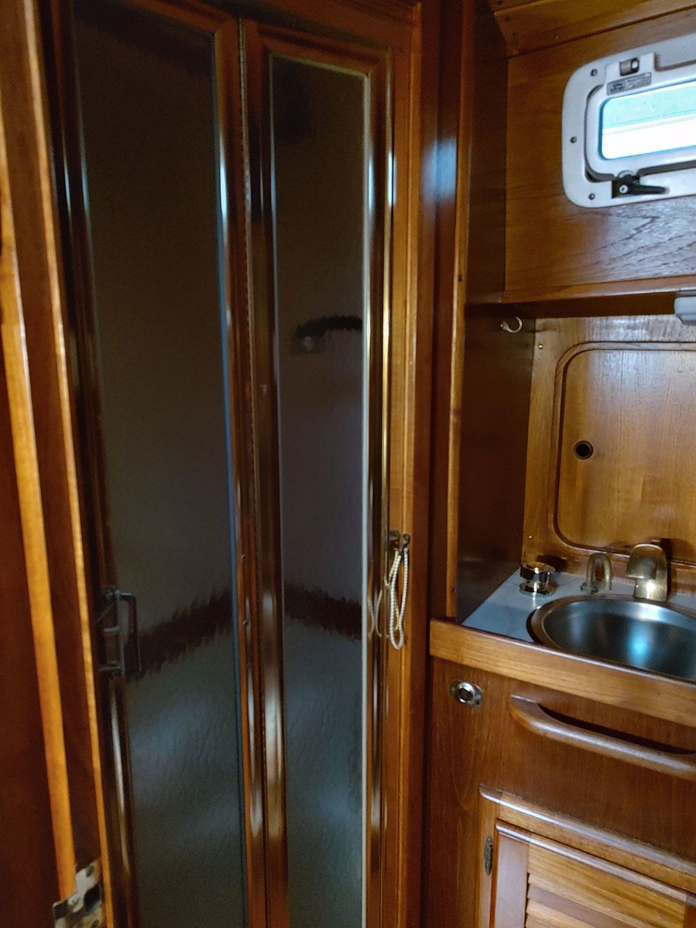 Head with enclosed shower with seat and raised enclosure for sale use underway.