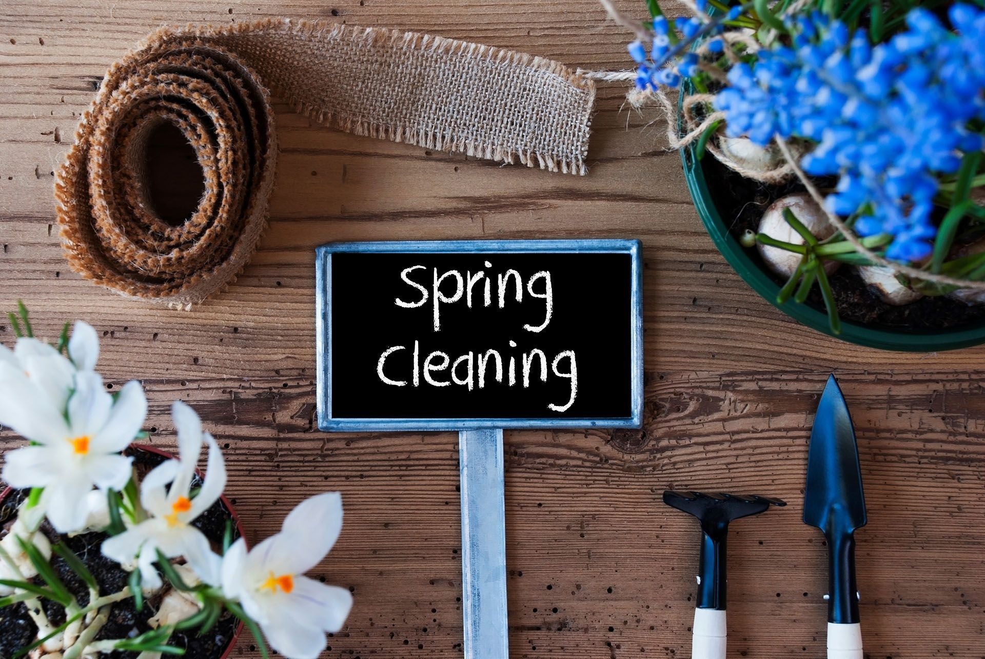 A wooden table with a sign that says spring cleaning