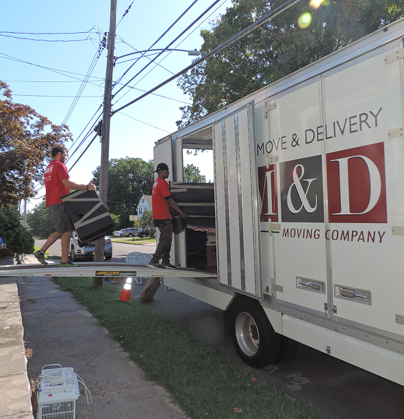 Smooth Move & Delivery team expertly maneuvering a moving truck in a tight parking area for a residential move in Norwalk.