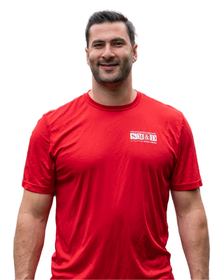 Man in red shirt smiling, outdoors.