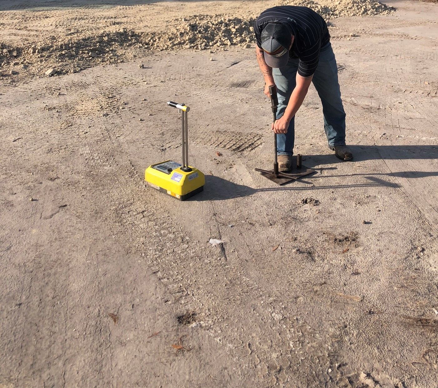 a man is digging in the dirt with a shovel