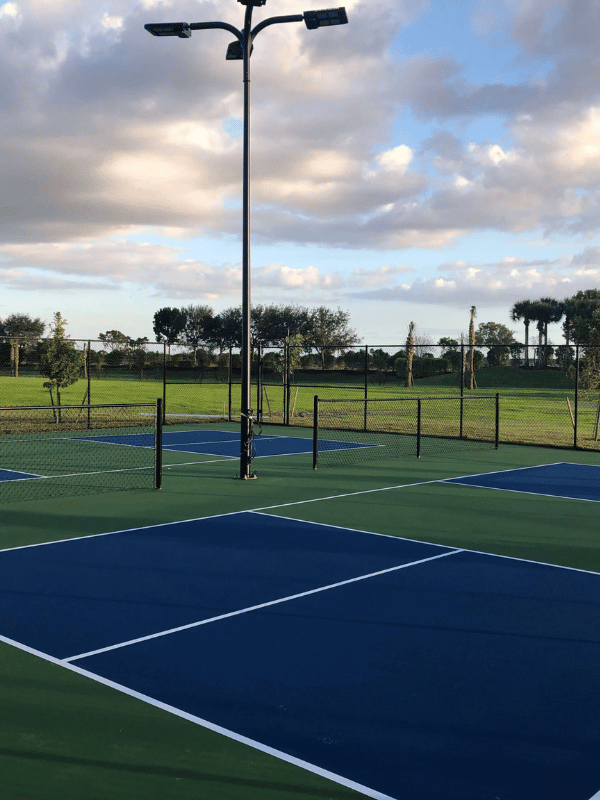 A tennis court with a lot of lights on it