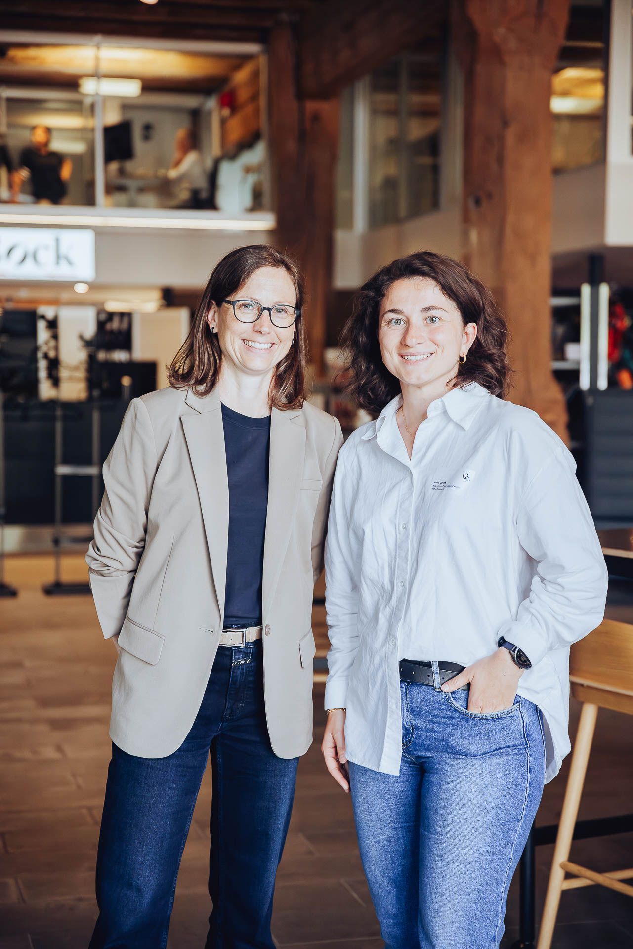 Two women are standing next to each other in a room.