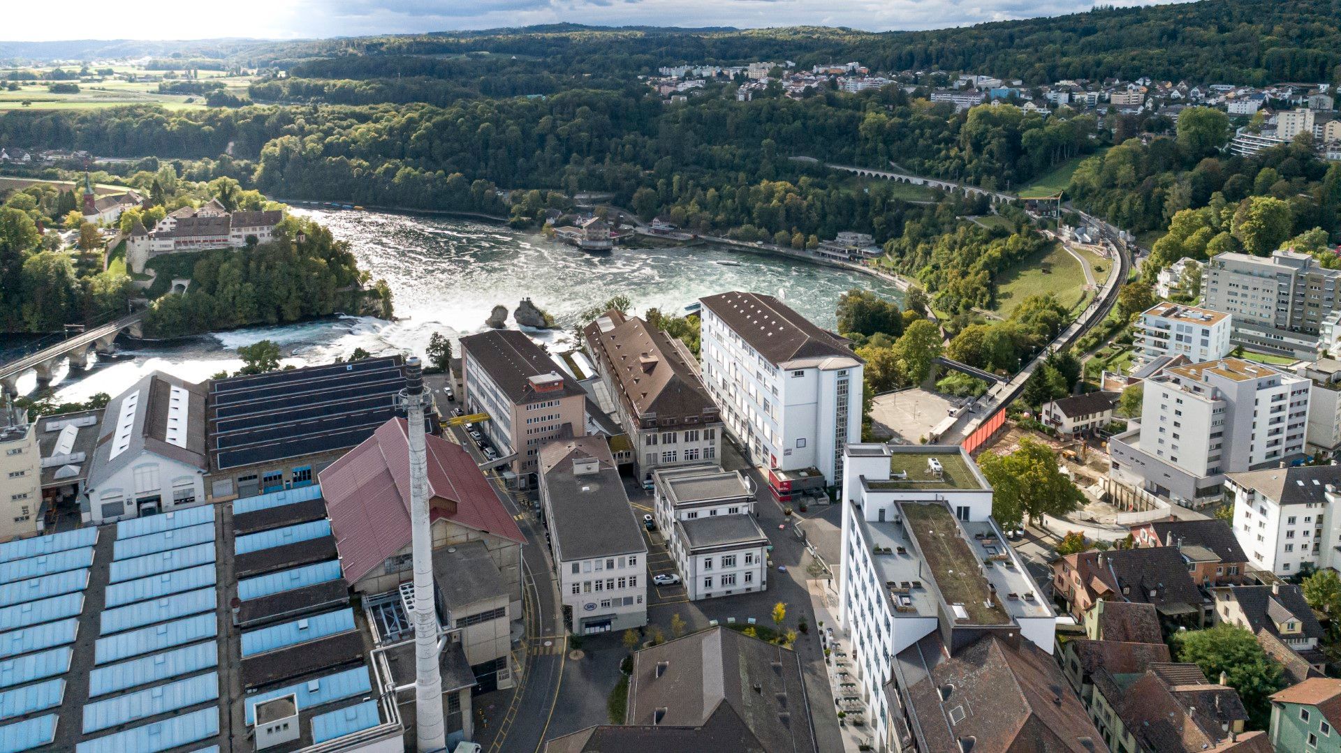 An aerial view of a city with a river in the background.